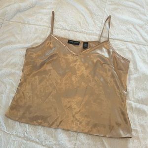 Valerie Steven’s gold silk tank top